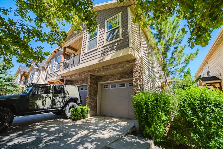 Contemporary multi-story exterior featuring a stone facade and horizontal siding