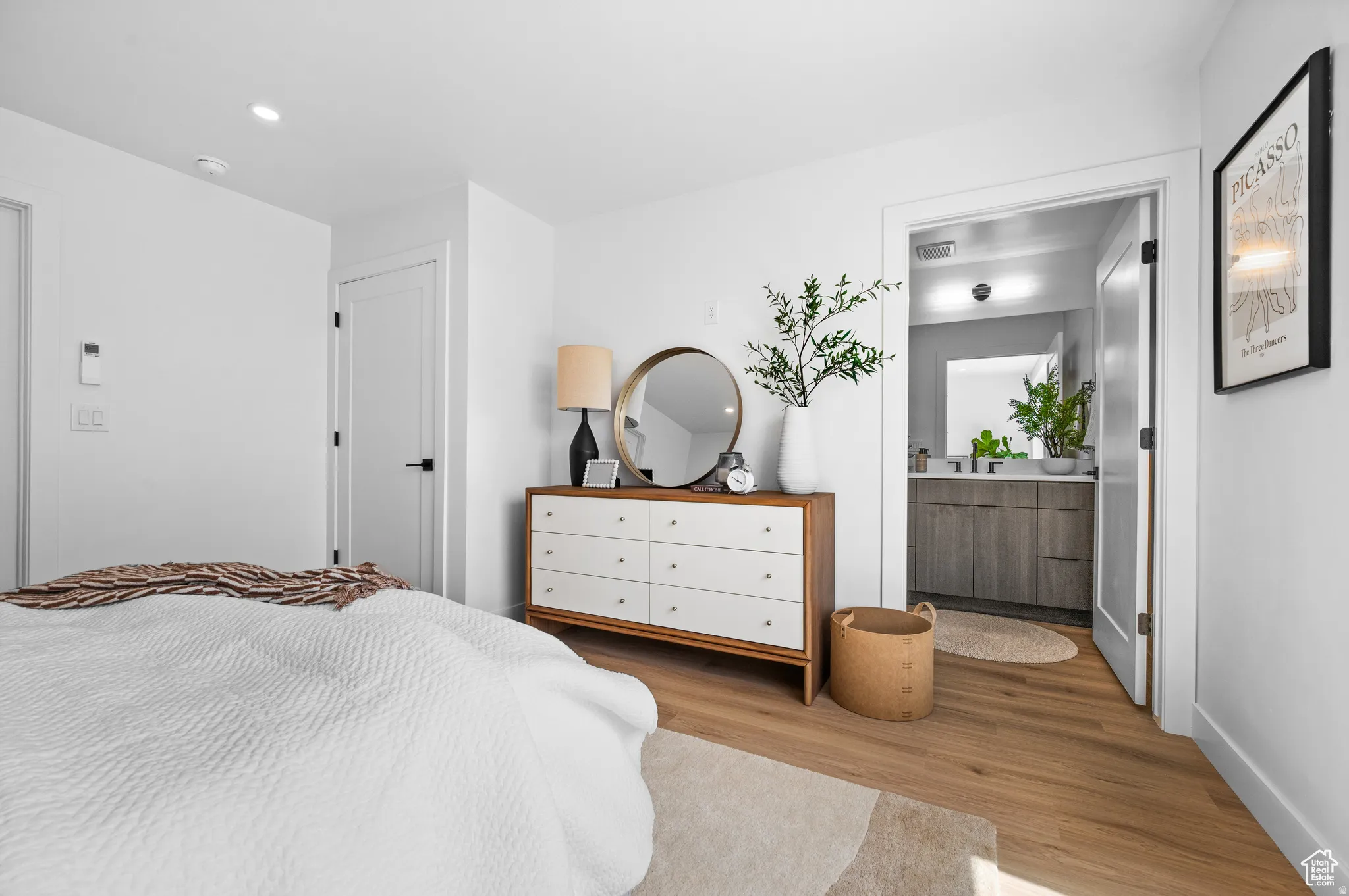 Bedroom featuring light wood-type flooring, recessed lighting, and ensuite bathroom