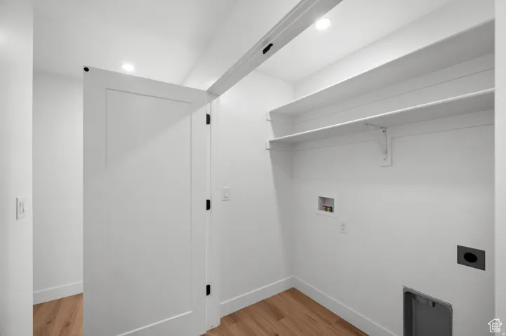 Laundry area with light wood-style floors, hookup for an electric dryer, recessed lighting, and hookup for a washing machine