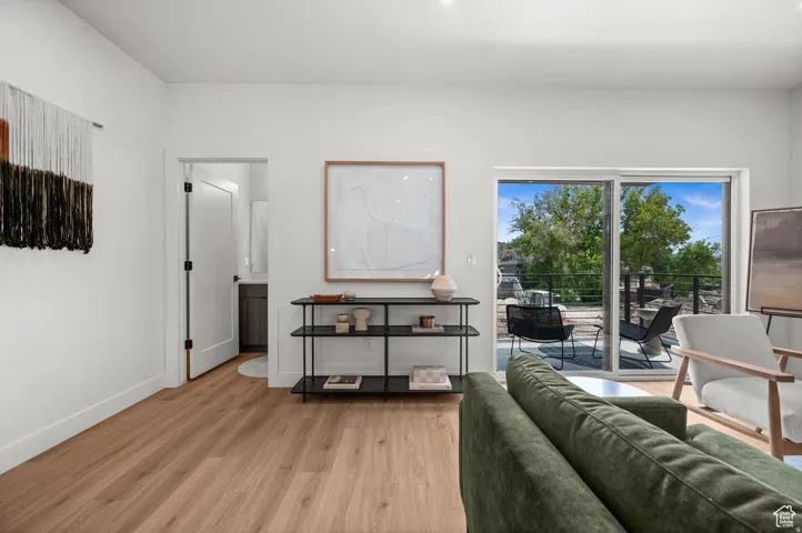 Living room featuring light wood-type flooring and baseboards