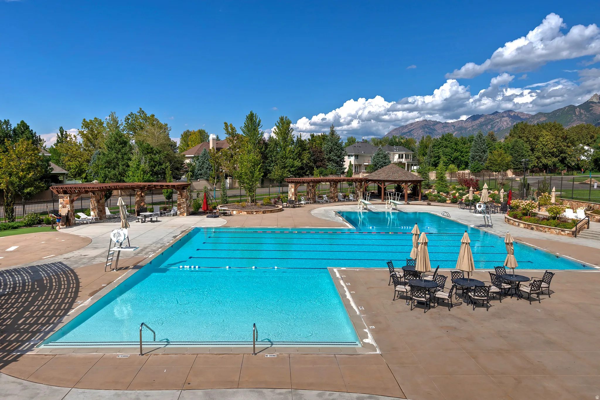 Community pool with a pergola, a patio, and a mountain view