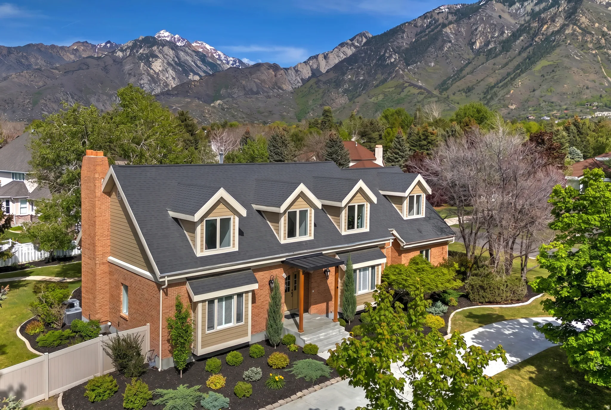 Cape cod house featuring stunning mountain views of the Wasatch Front! All renovated.  (landscaped AI enhanced)