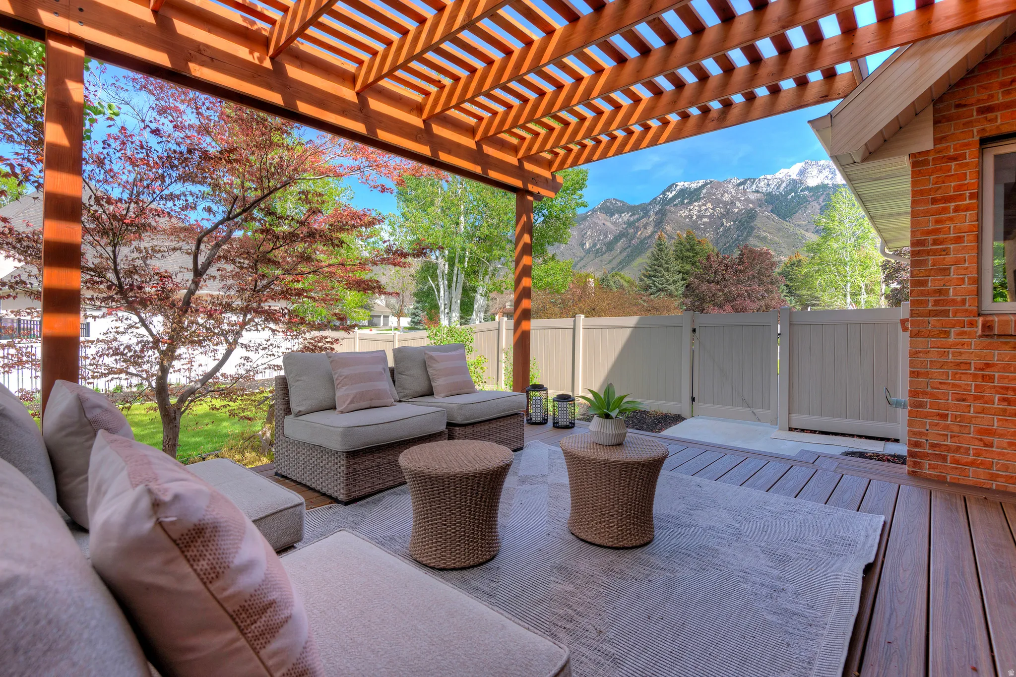 Fenced backyard featuring a pergola, a mountain view, and an outdoor hangout area