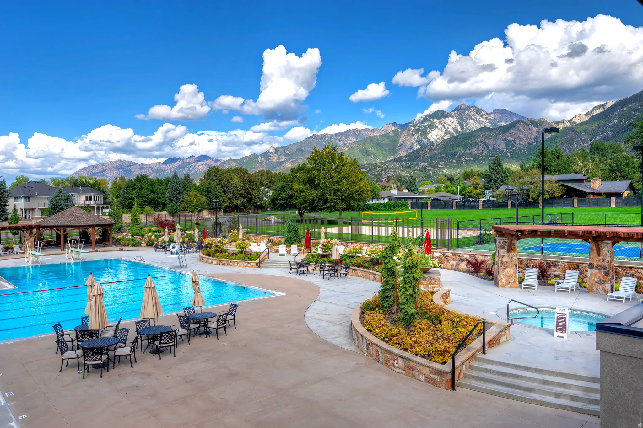 Community pool featuring a patio area, a mountain view, a gazebo, and a residential view