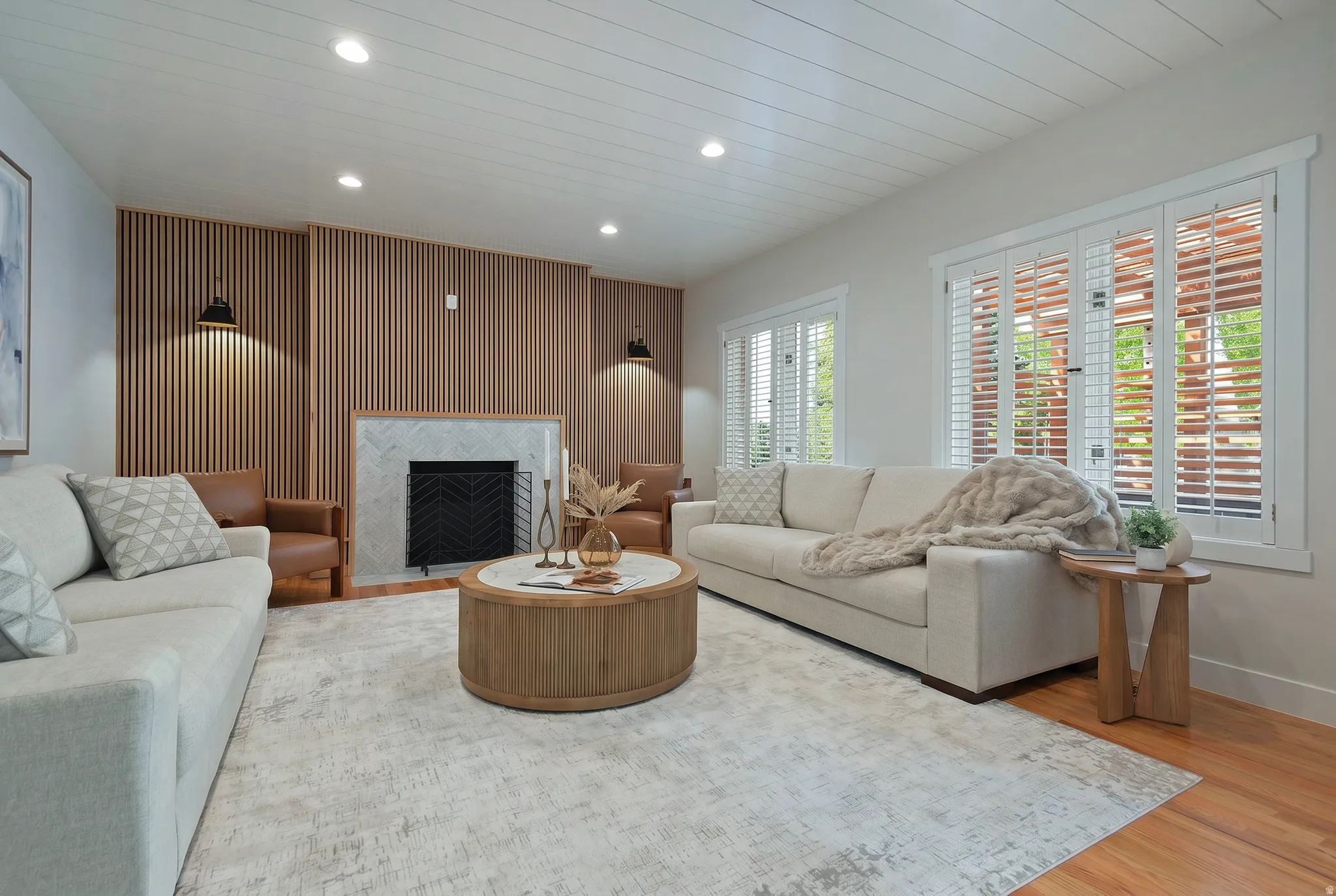 Family room featuring wood accented walls, recessed lighting, a fireplace with flush hearth, light wood-style floors