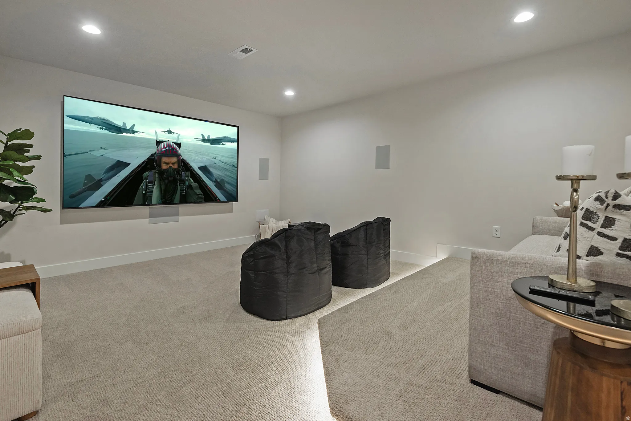 Home theater with light carpet and recessed lighting