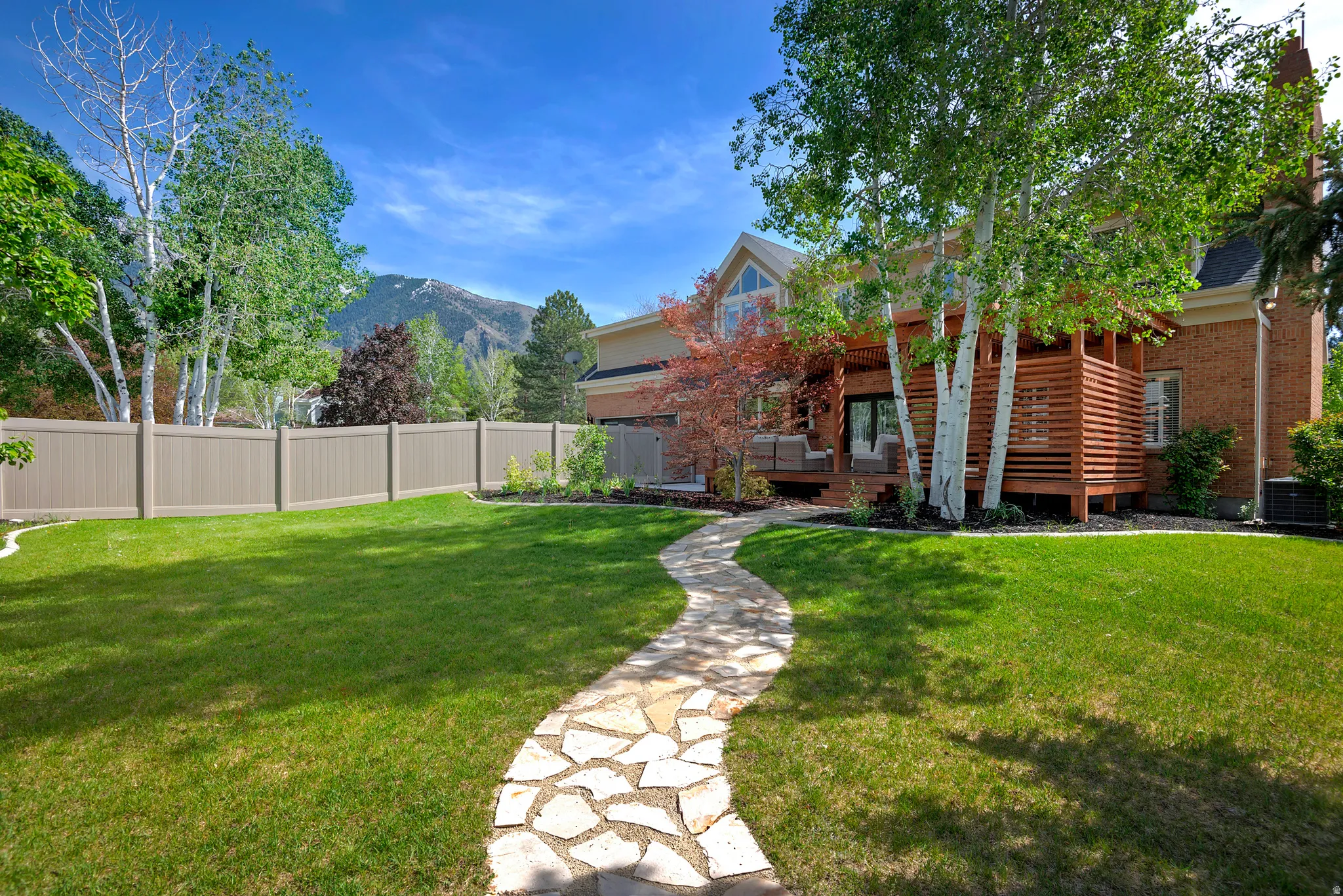 Fenced yard with a covered deck, private yard and mountain views