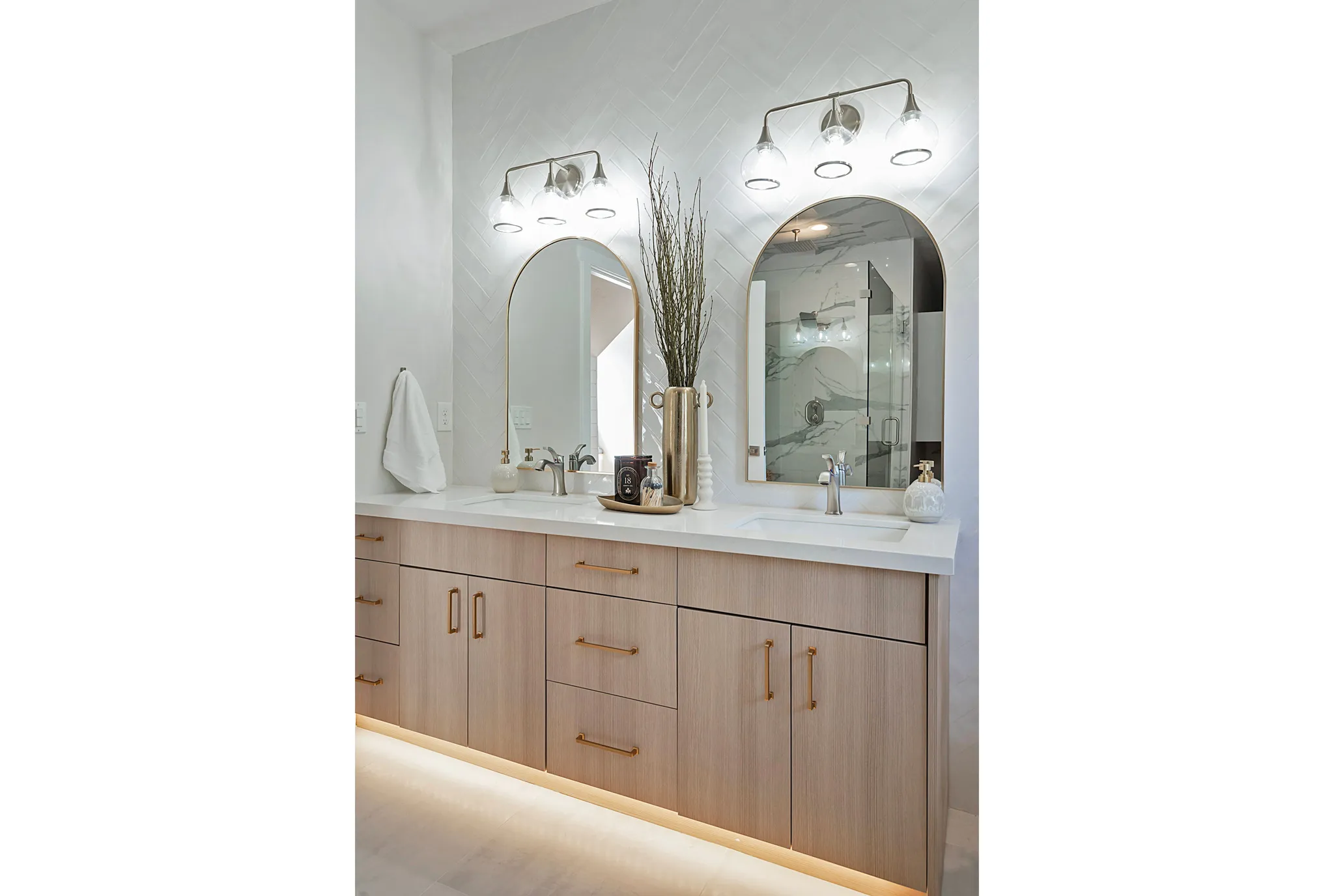 Bathroom with double vanity and a marble finish shower