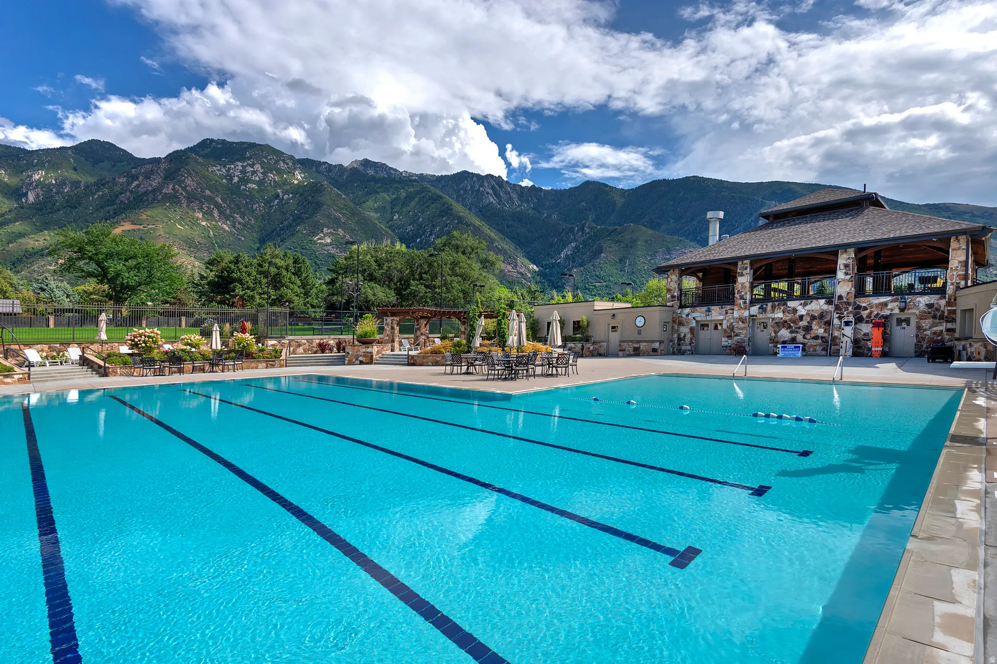 Community pool featuring a patio area, a mountain view, and a gazebo
