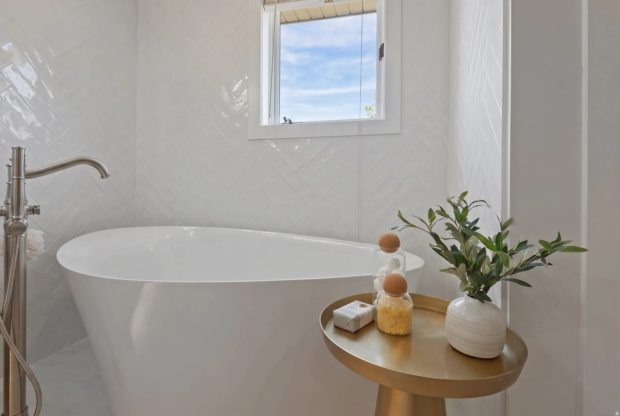Full bathroom featuring a soaking tub and tile walls
