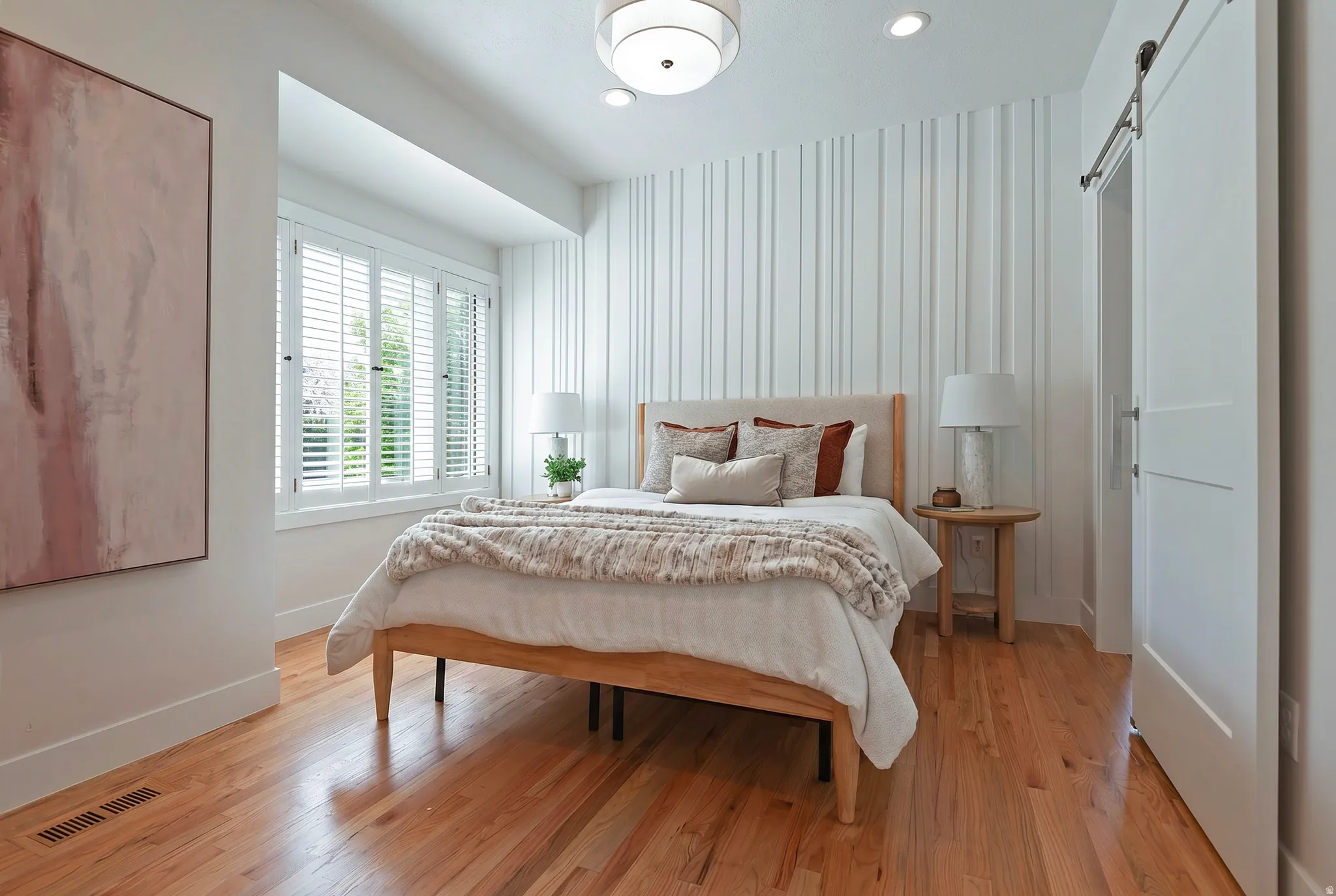 Main floor en suite bedroom featuring a barn door