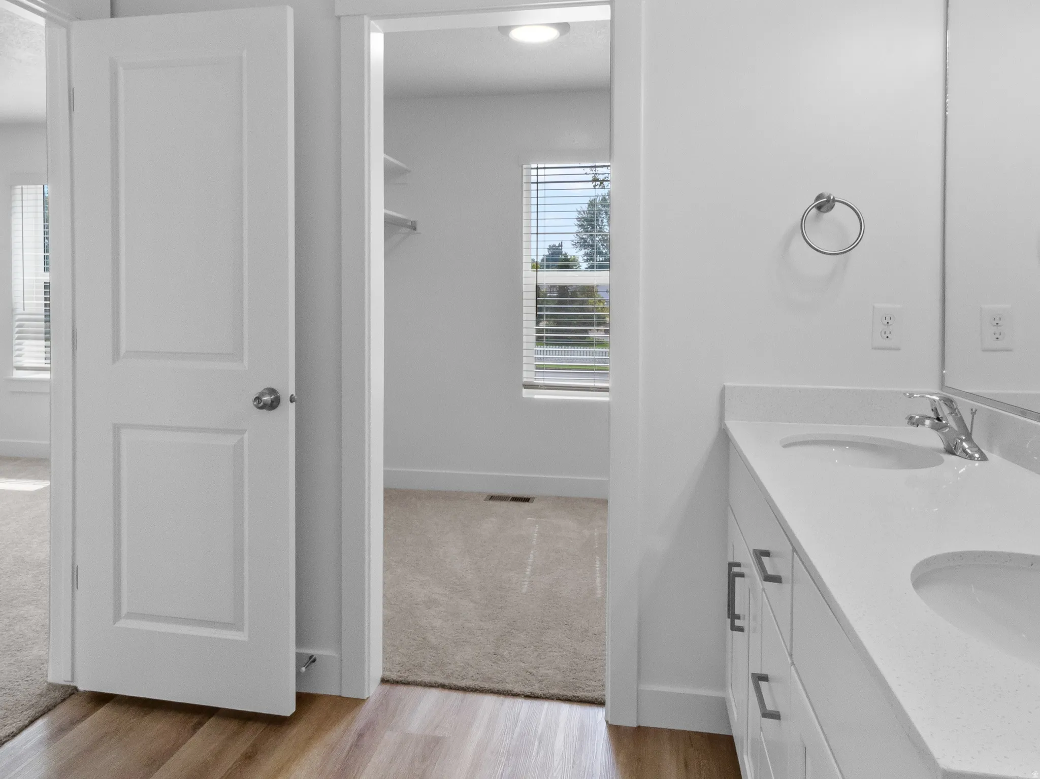 Dual vanity with integrated sinks and white cabinetry
