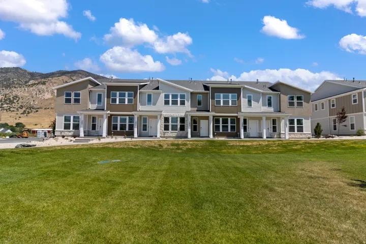 Townhome exteriors featuring various sidings, stone accents, and covered entryways