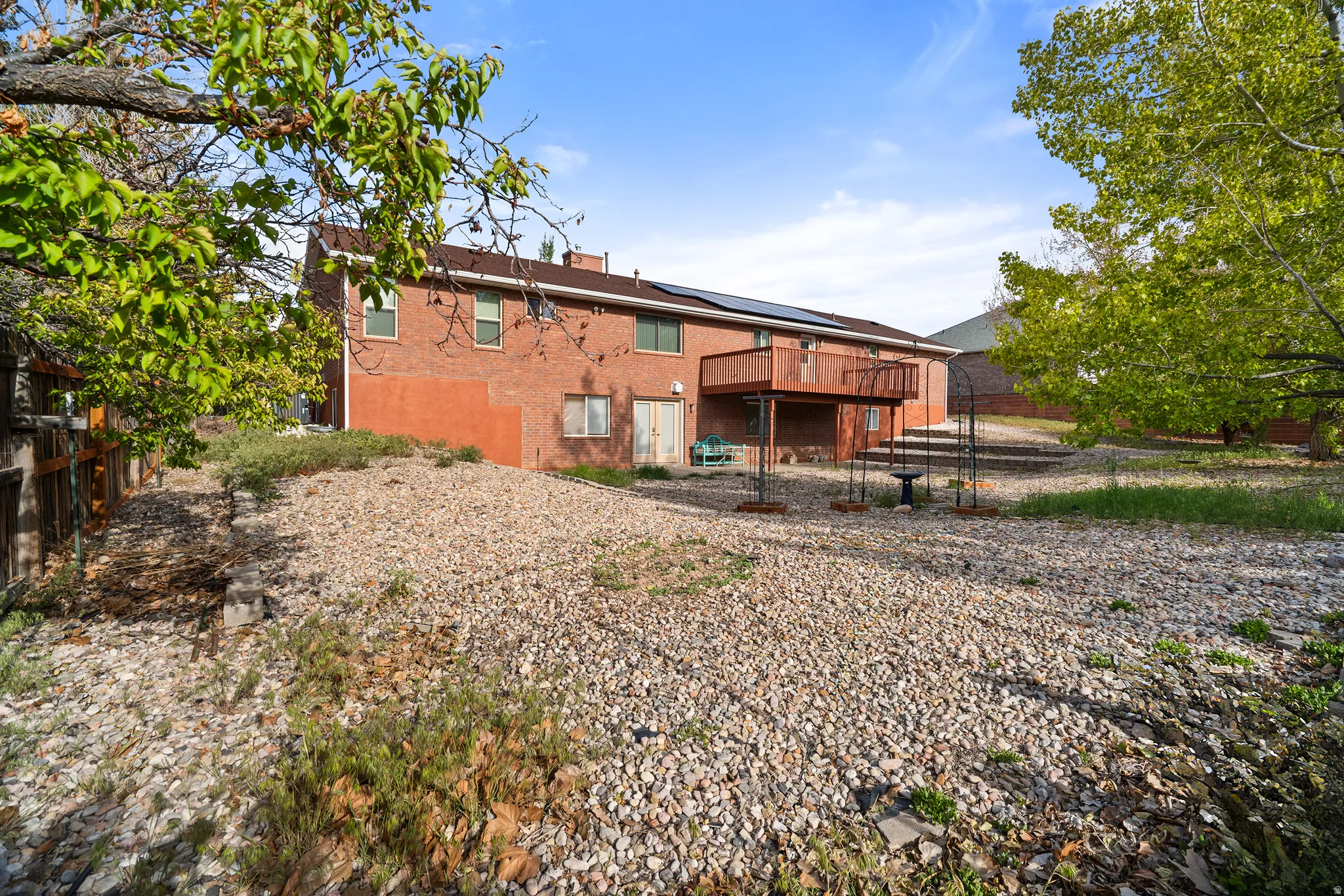Brick exterior with upper-level wood deck
