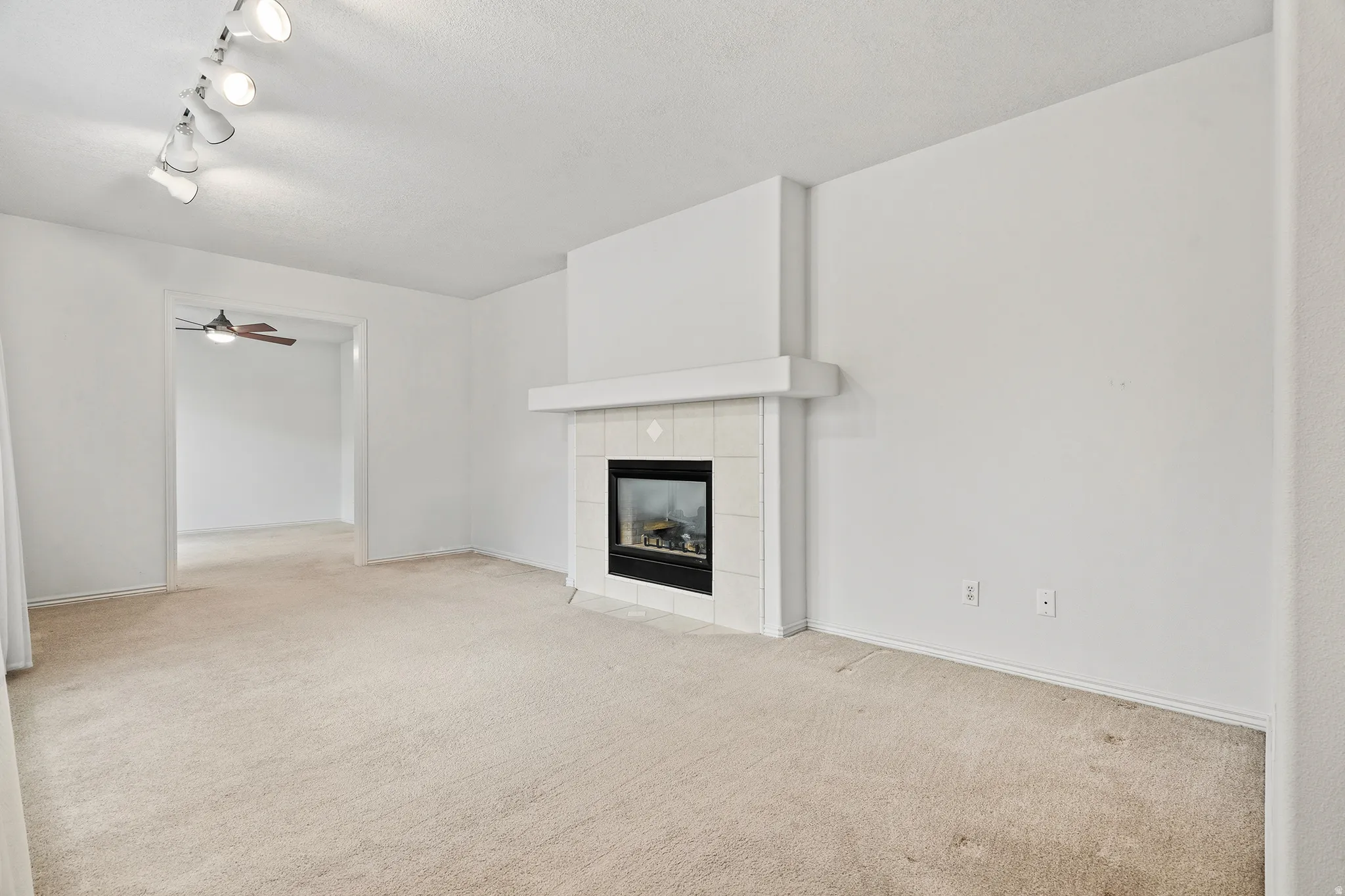 Living area featuring a fireplace with a tiled surround and mantel