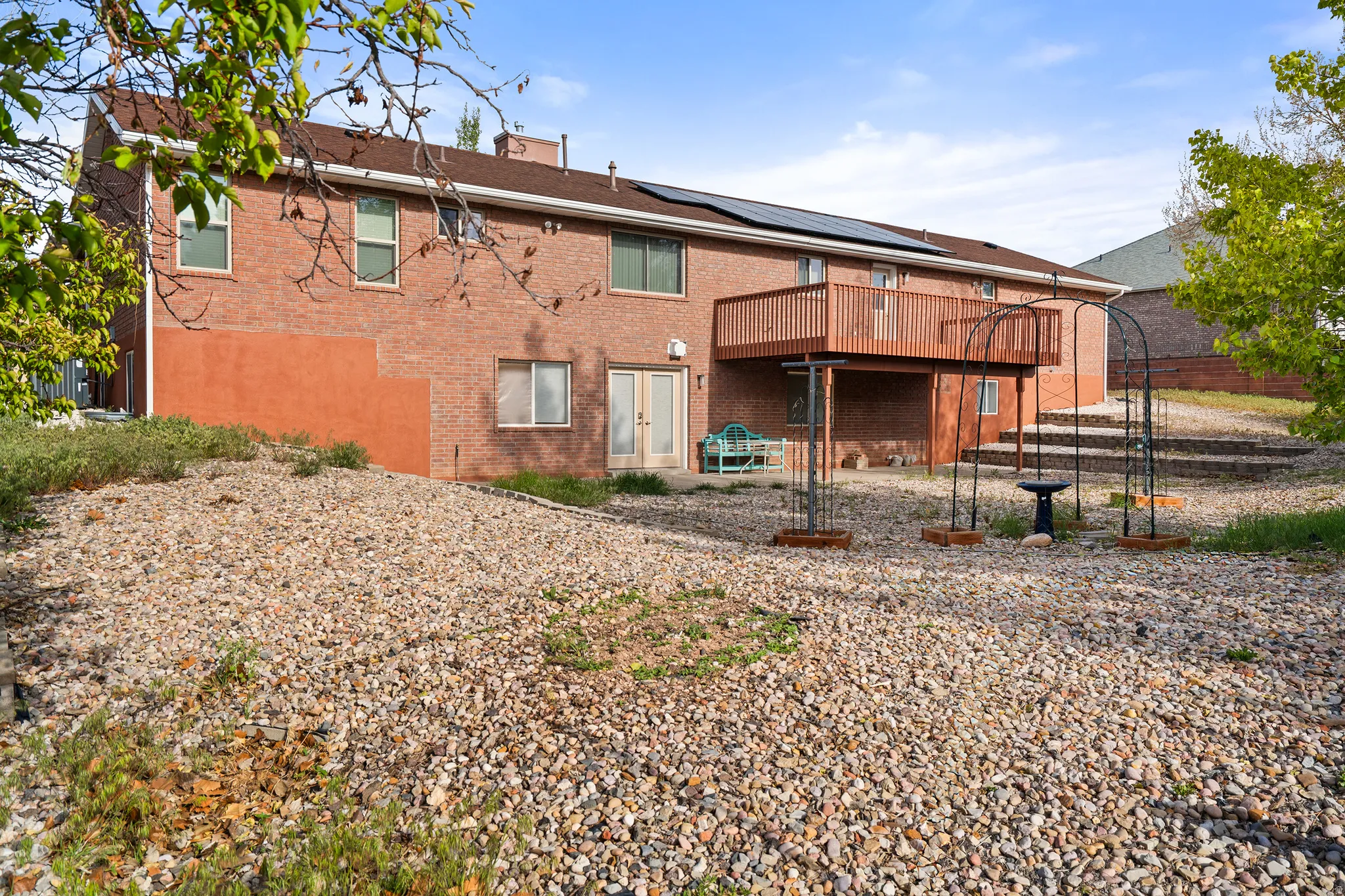Rear exterior featuring brick and stucco facade