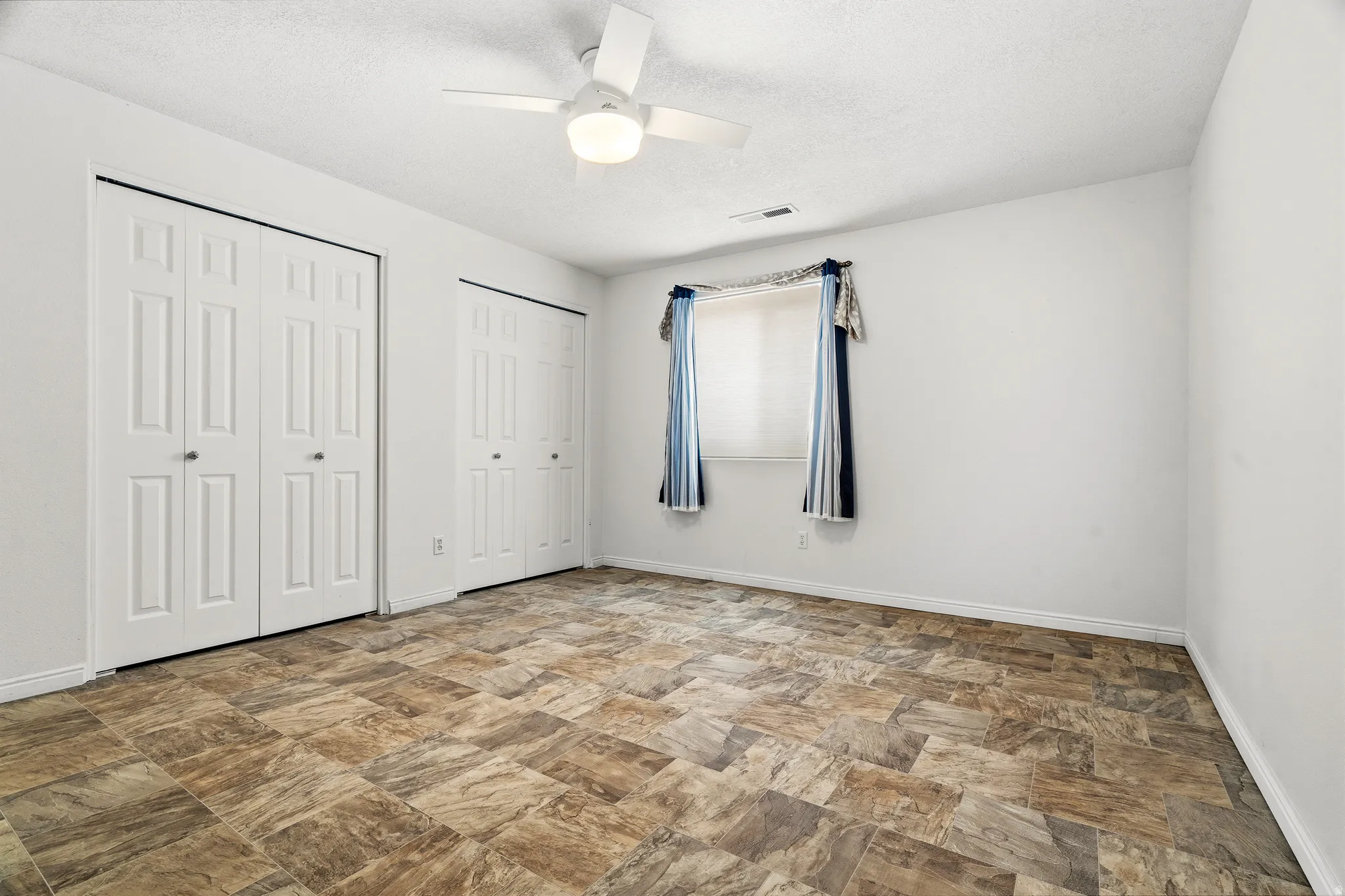 Neutral wall finishes complement the patterned floor tiles