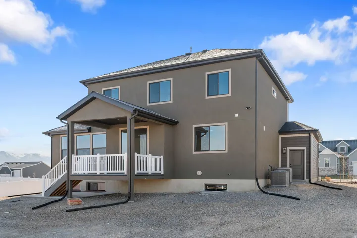 Contemporary residence with a covered patio featuring white railings