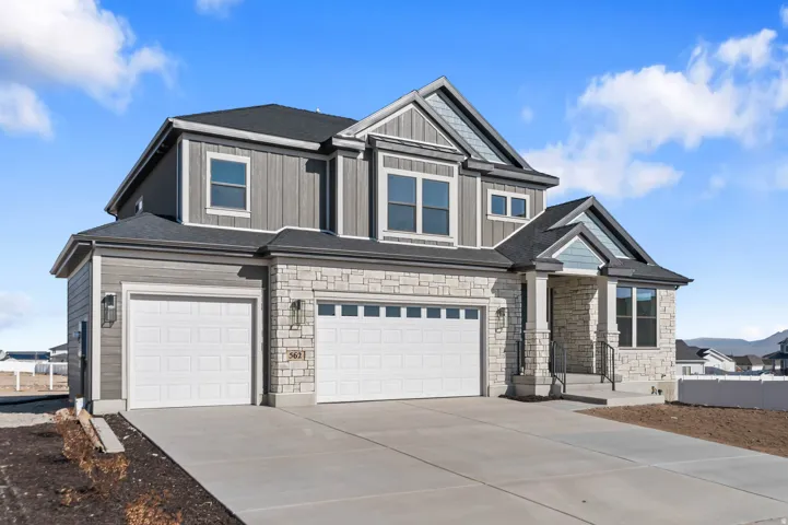Contemporary two-story residence with a stone and siding exterior