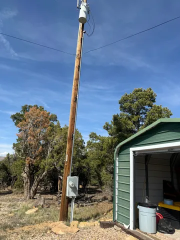 Utility pole with meter box and electrical service