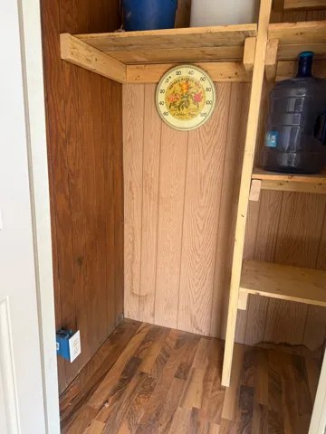 Built-in shelving unit featuring wood-finish flooring