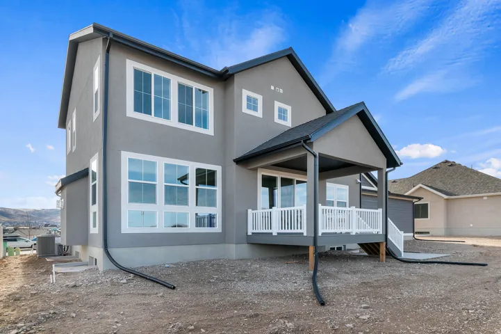Contemporary two-story exterior with a covered deck and white railing