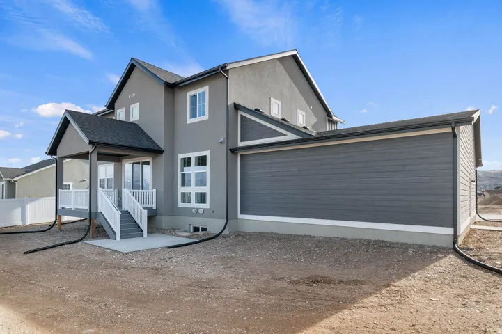 Contemporary exterior featuring light gray stucco and dark gray horizontal siding