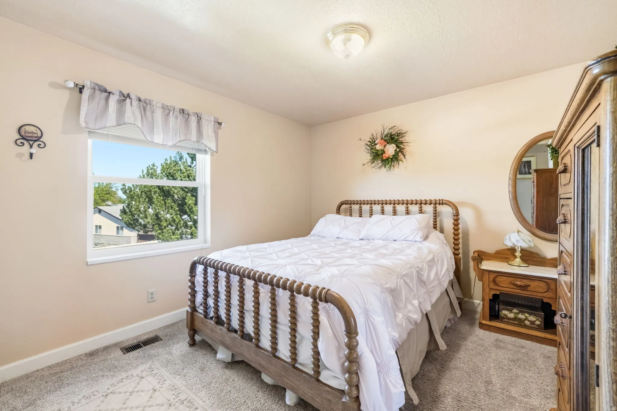 Carpeted room featuring a double-paned window with exterior views, neutral wall color, and a flush-mount ceiling light fixture