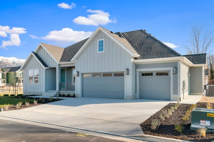 Contemporary farmhouse-style exterior featuring light gray board-and-batten siding