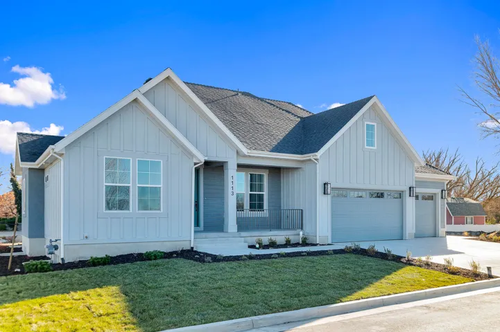Light blue siding exterior featuring a dark asphalt shingle roof