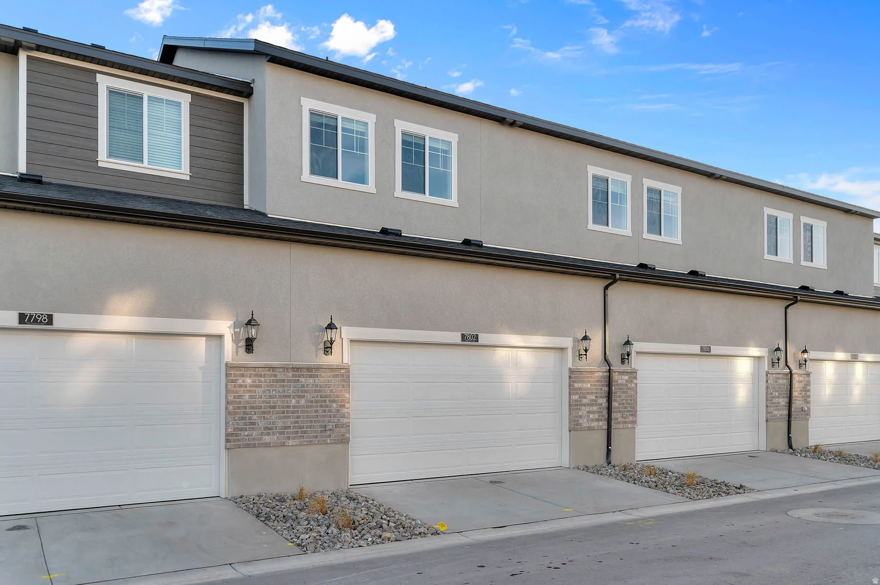 Contemporary townhome-style residences featuring stucco and siding exteriors
