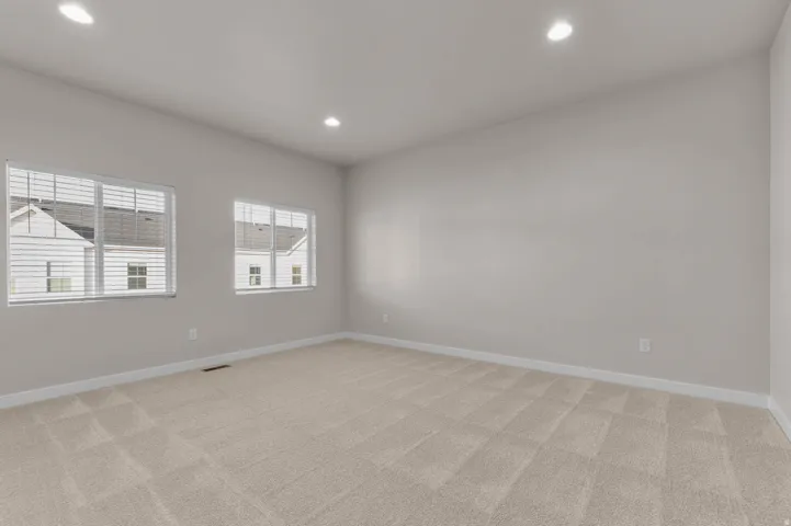 Spacious room with plush carpeting and neutral wall tones
