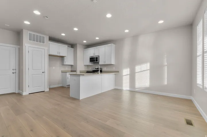 Open-concept living space with light wood-finish flooring
