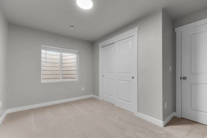 Light gray painted walls with white trim and neutral carpeting