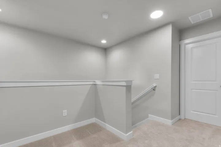 Bright interior space featuring neutral wall paint, white baseboards, and matching white trim details