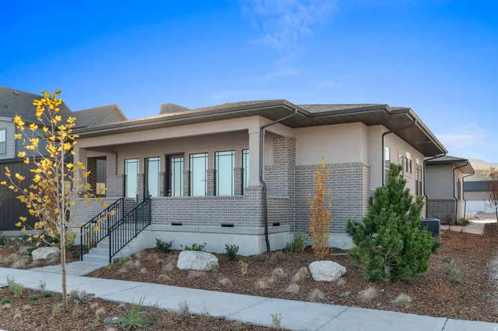 Contemporary exterior showcasing a blend of light gray brick and stucco finishes