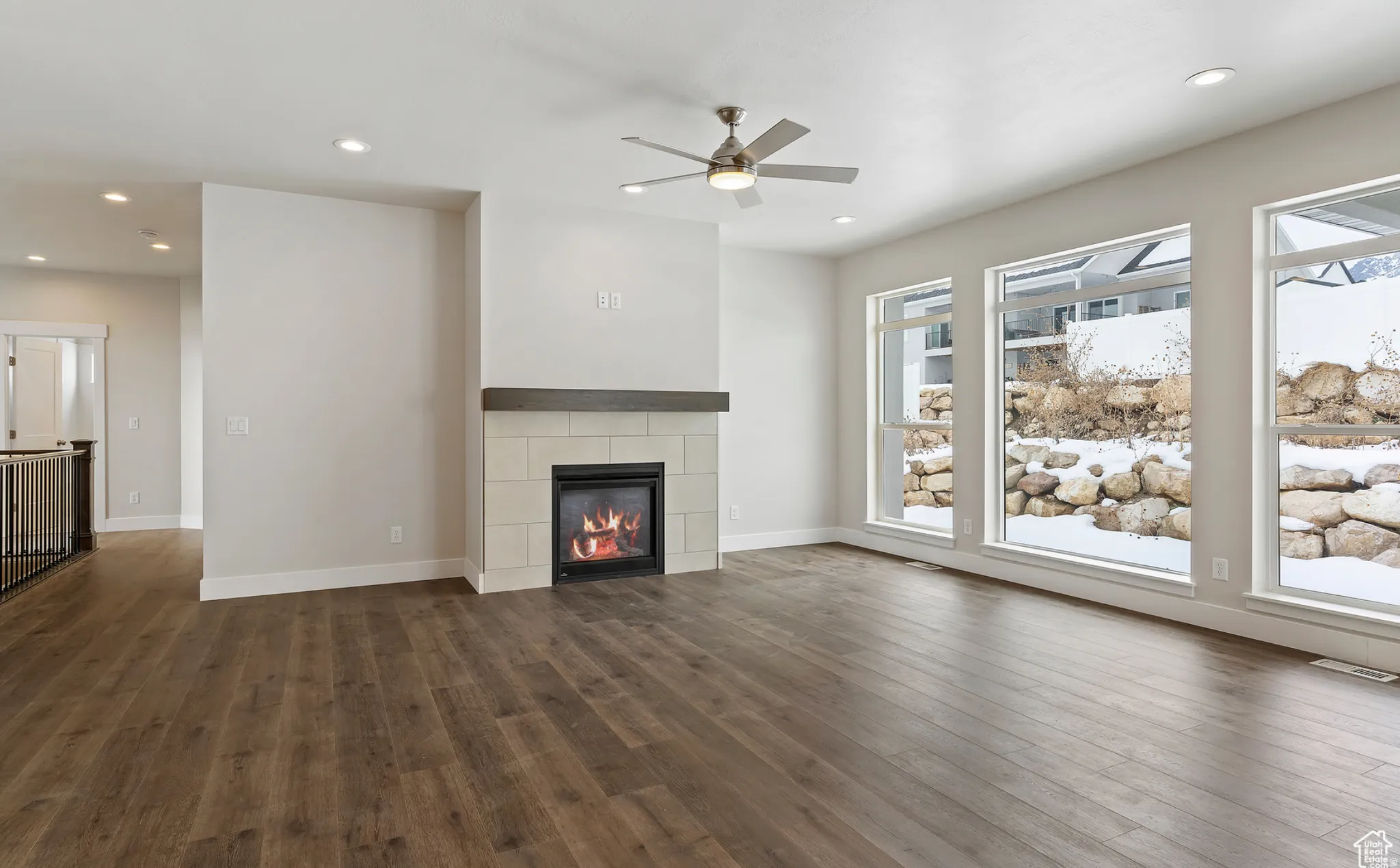 Unfurnished living room with a tile fireplace, ceiling fan, dark wood-type flooring, and recessed lighting