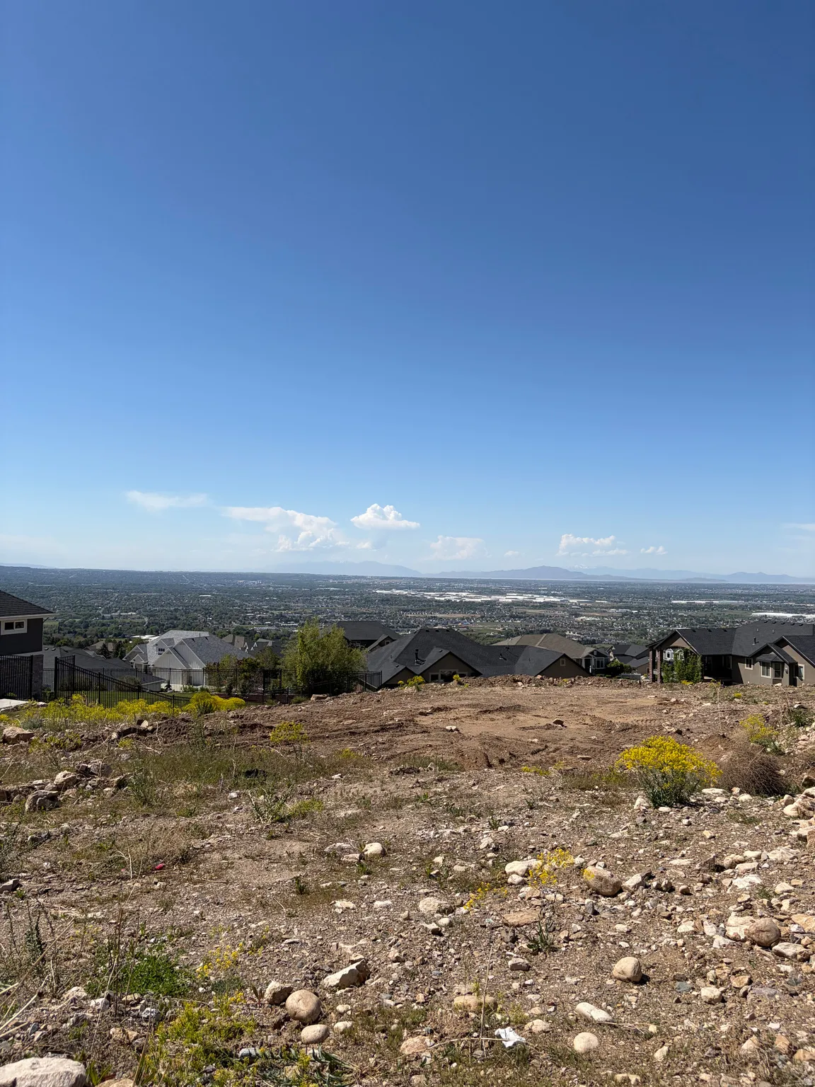 Elevated building lot featuring a level pad and distant landscape