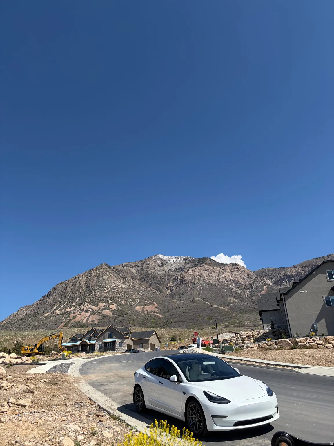 Newly paved street with visible mountain backdrop