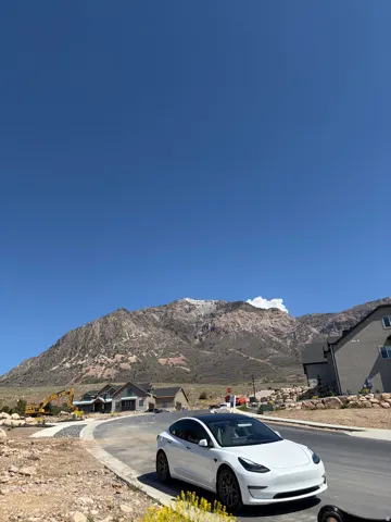 Newly paved street with visible mountain backdrop