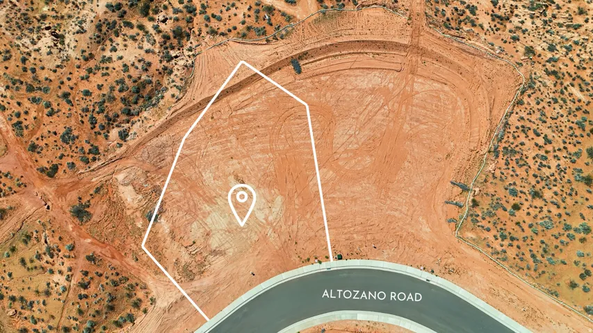 Aerial view of a cleared lot featuring red earth terrain, a marked property boundary, direct road frontage on Altozano Road, and surrounding undeveloped land