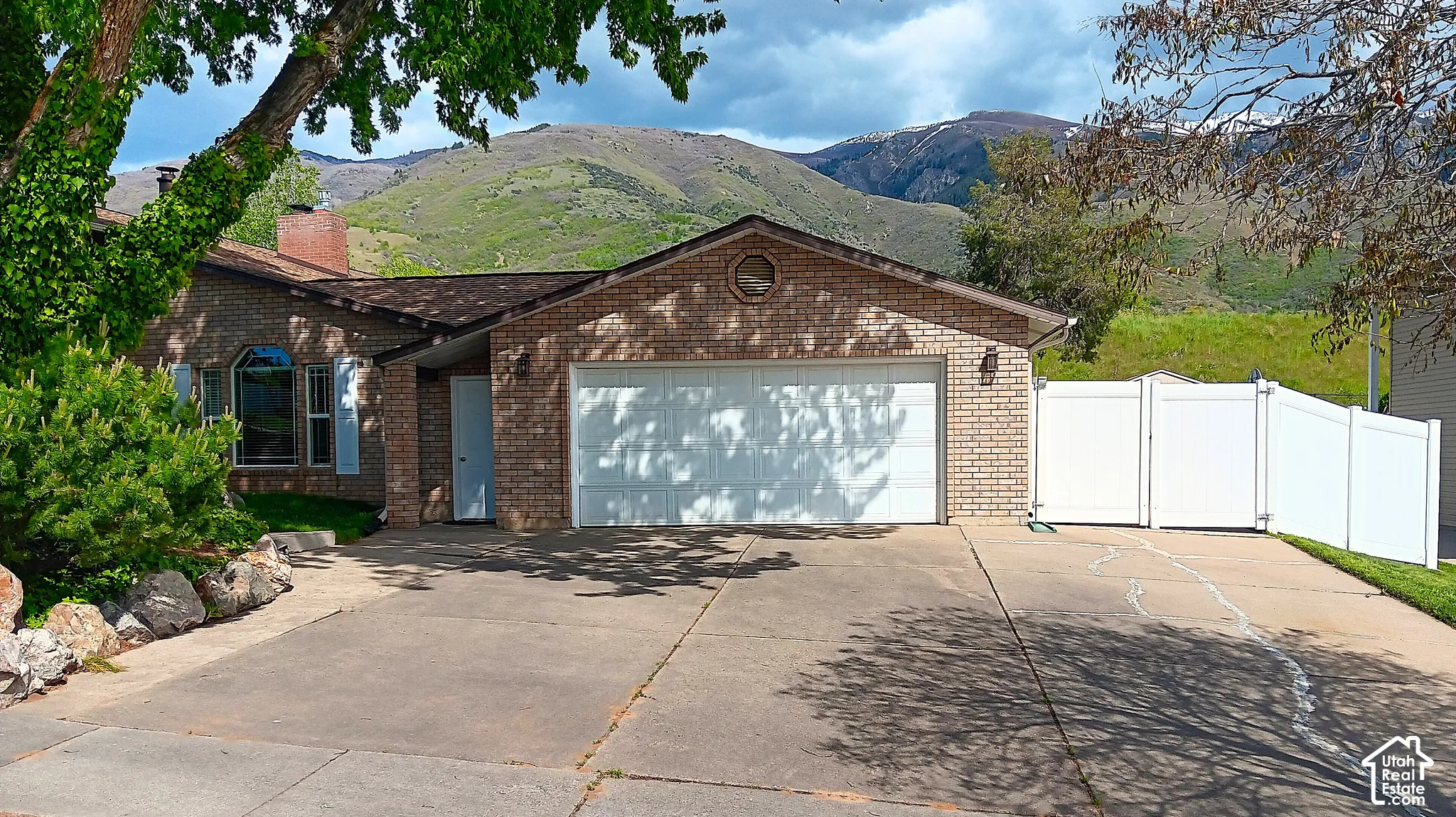 Brick exterior with a two-car garage and a lower entrance