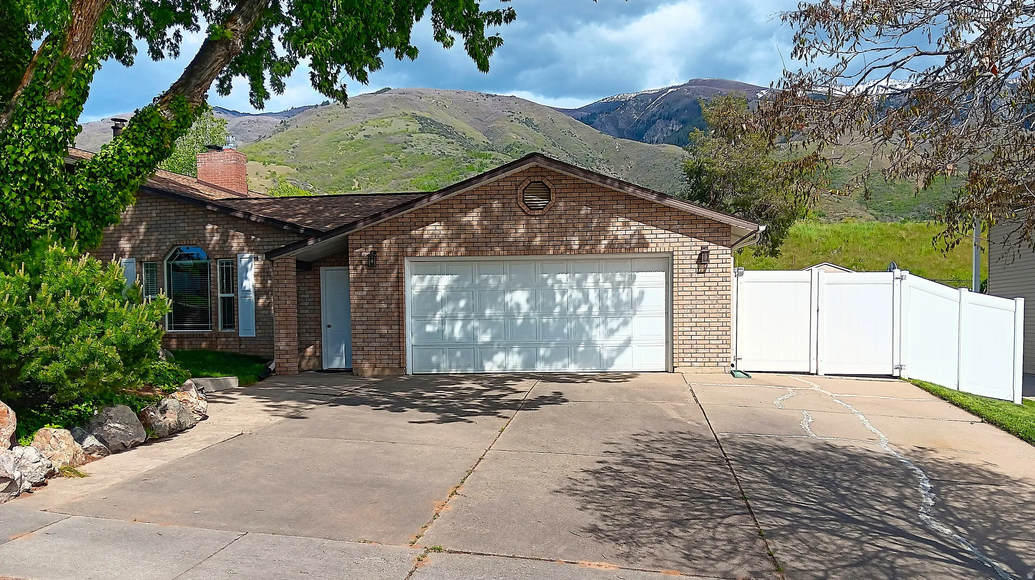Brick exterior with a two-car garage and a lower entrance