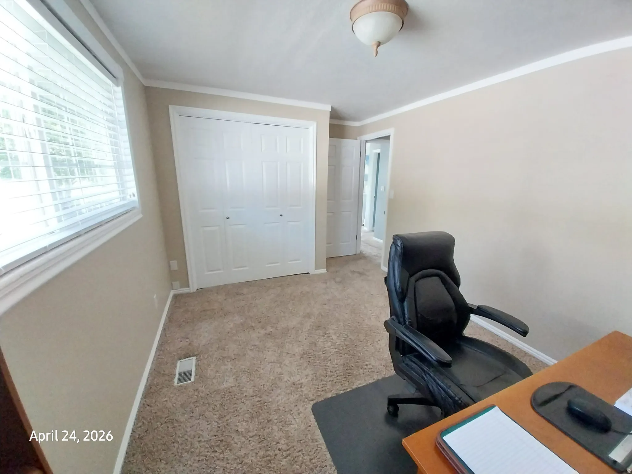 Office space with light colored carpet and crown molding
