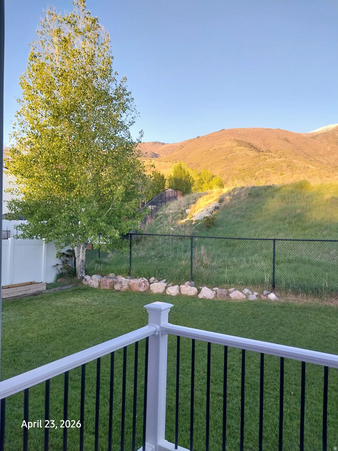 Fenced backyard, master bedroom view, with a mountain view and a balcony
