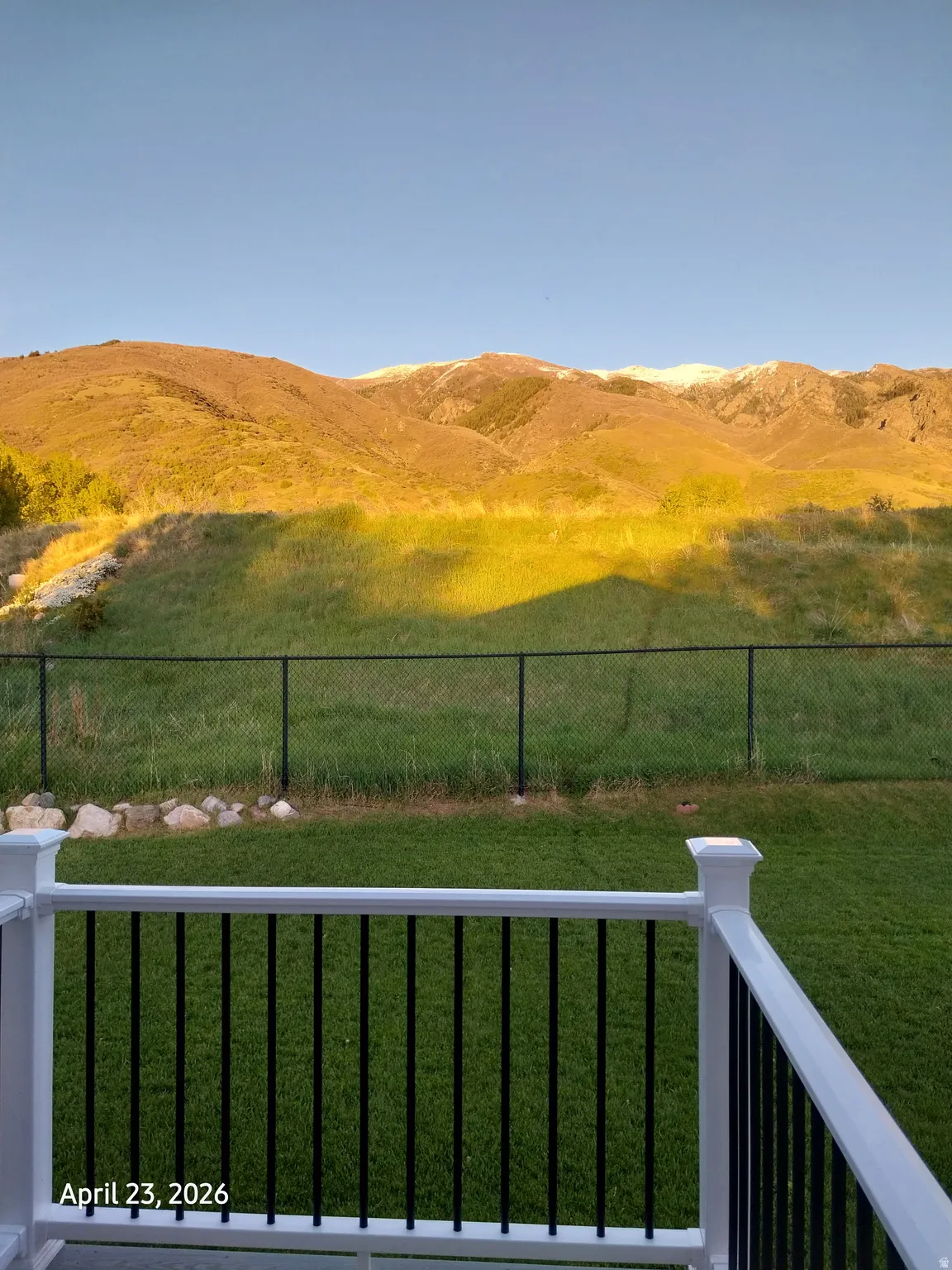 Master bedroom balcony view of yard with a mountain view