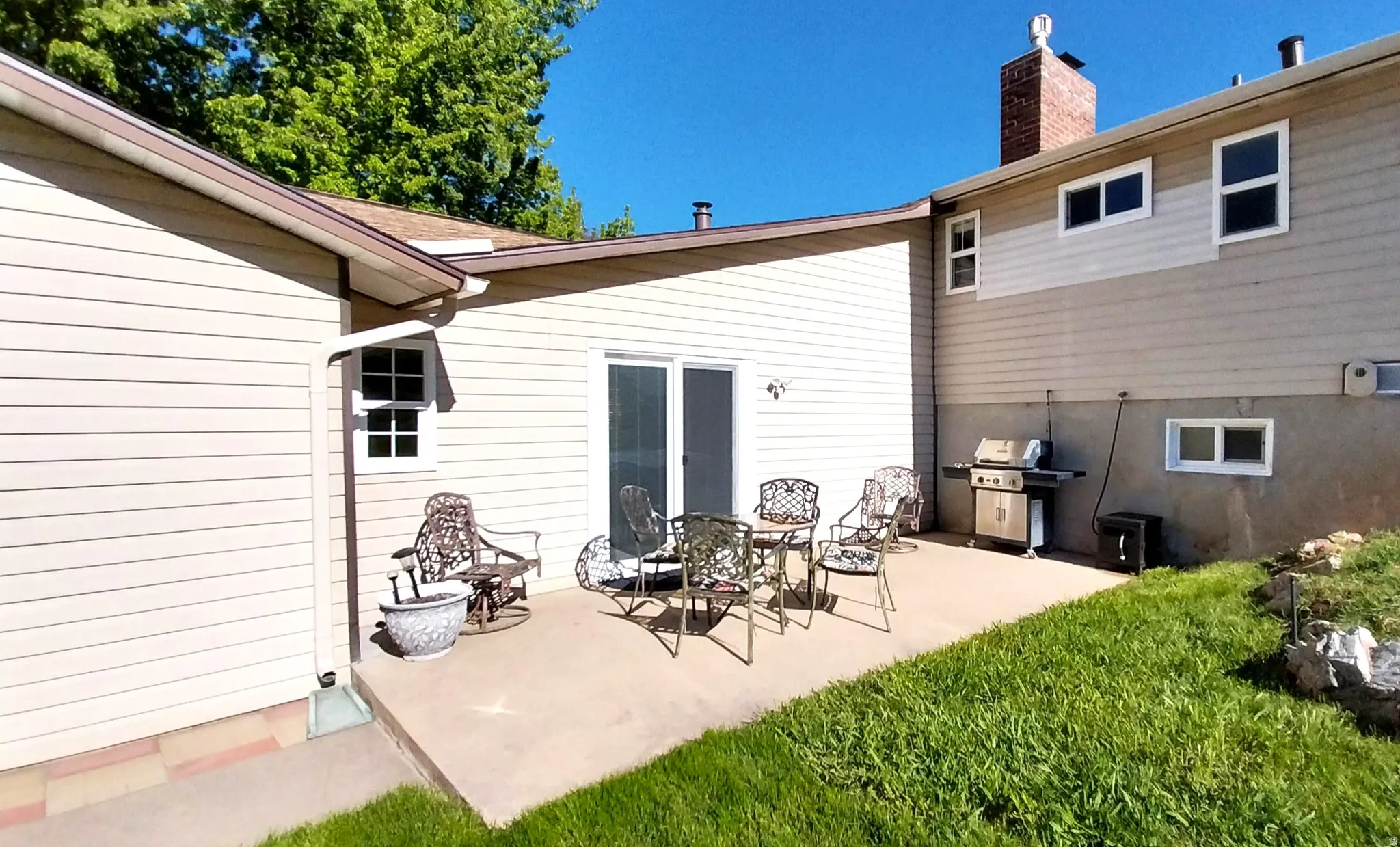 Rear view of property with a patio area and a chimney