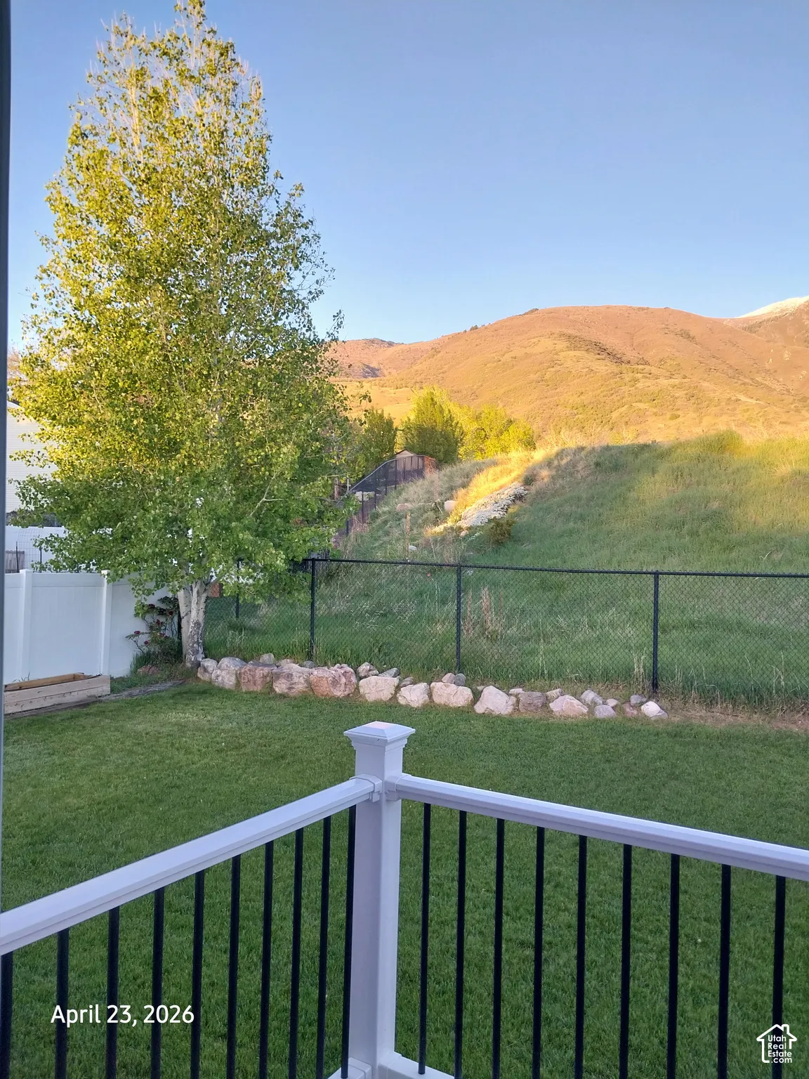 Fenced backyard, master bedroom view, with a mountain view and a balcony