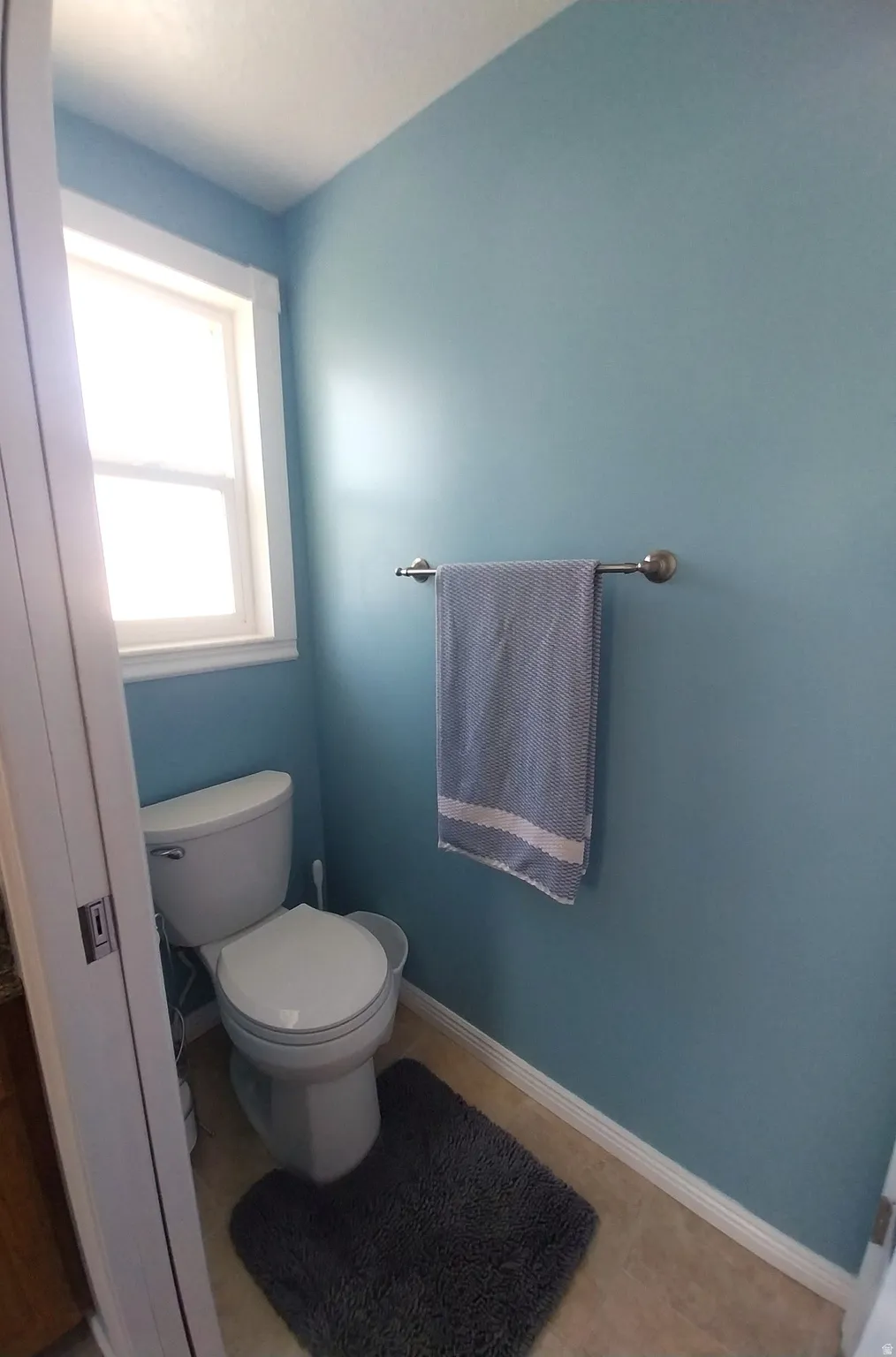 Bathroom featuring baseboards and light tile patterned floors