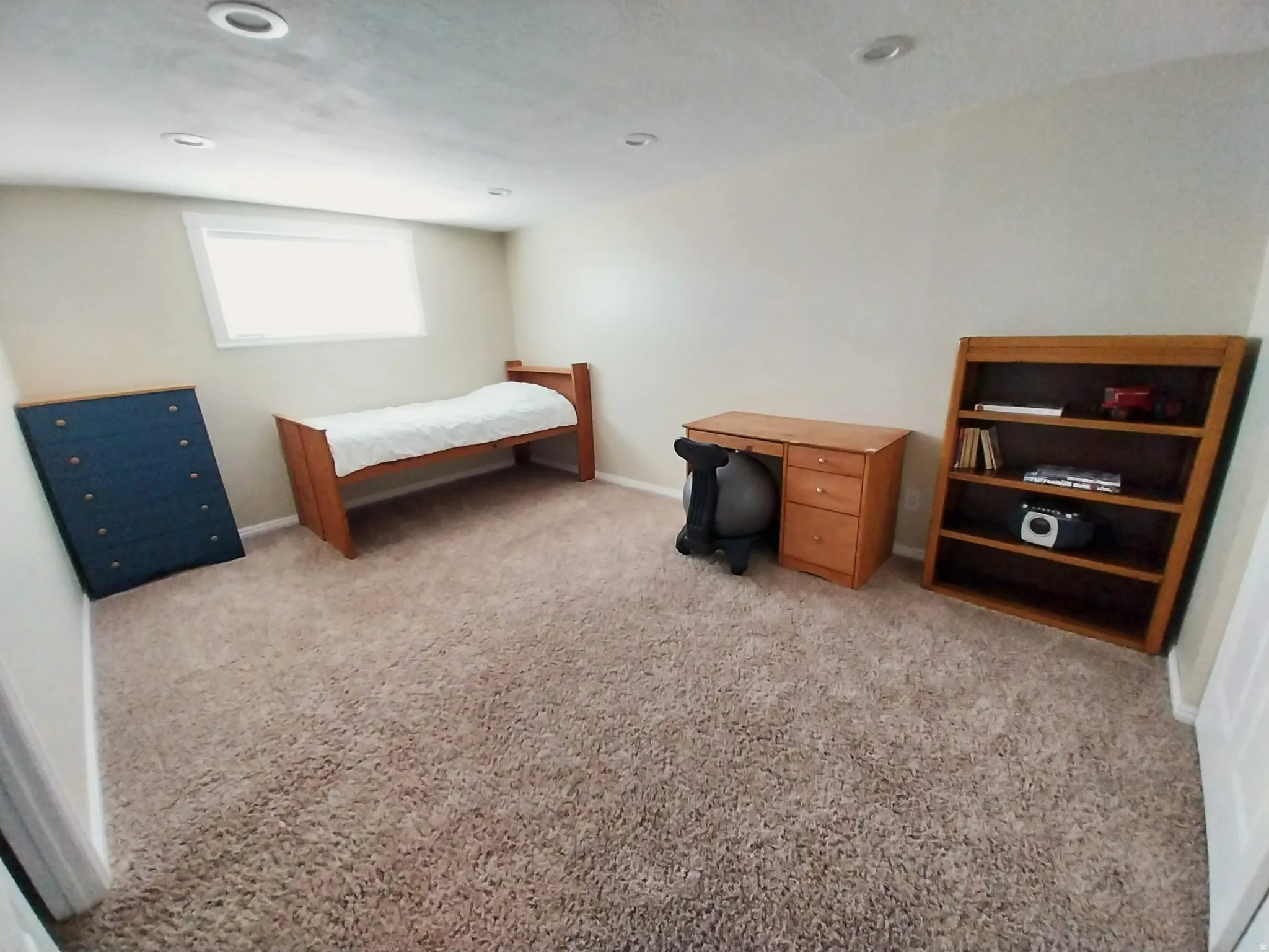 Bedroom with light colored carpet and baseboards